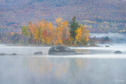 View of colorful trees at Leffert's Pond in Vermont during fall season.