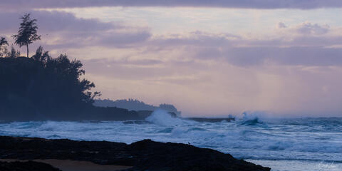 Dramatic clouds and waves at Secret Beach on Kauai's north shore in Hawaii.