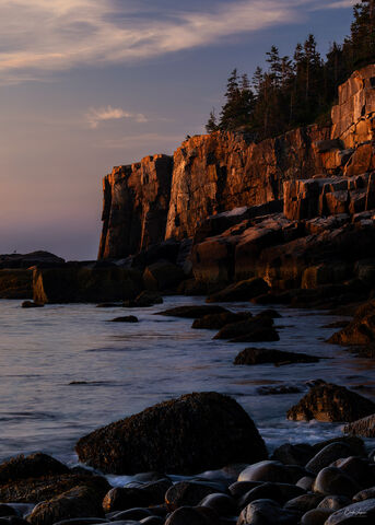 View of Otter Cliff at Boulder Beach in Acadia National Park at sunrise.