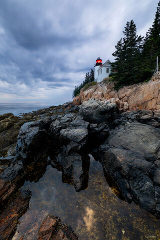 View of Bass Harbor Head Lighthouse at sunset in Acadia National Park in Maine.