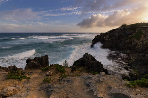 Overlook on the breaking waves and cliffs from Mahaulepu Heritage Trail near Shipwreck Beach on Kauai island in Hawaii.