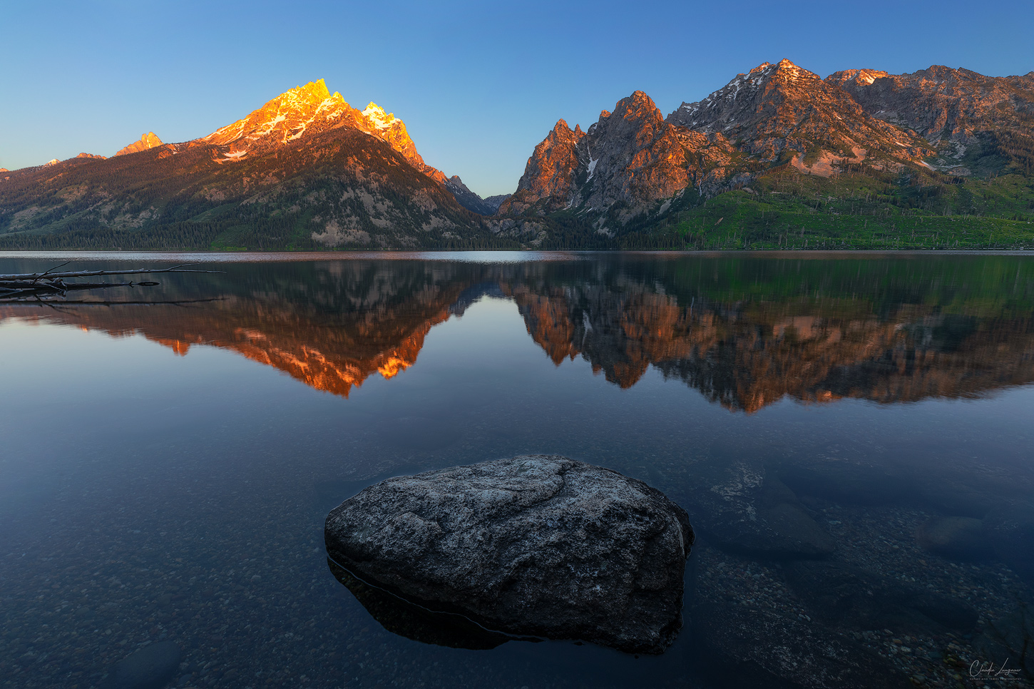 A reflection of Grand Teton Mountain Range in Jenny Lake at Grand Teton National Park.