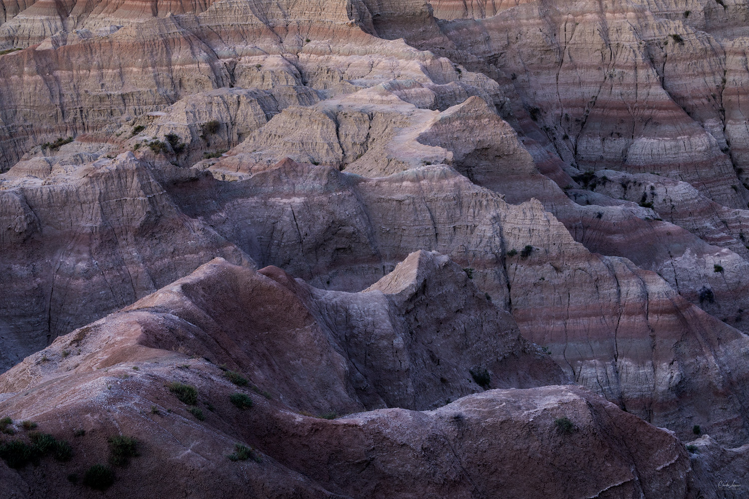 View of colorful buttes at Badlands National Park in South Dakota at sunset.