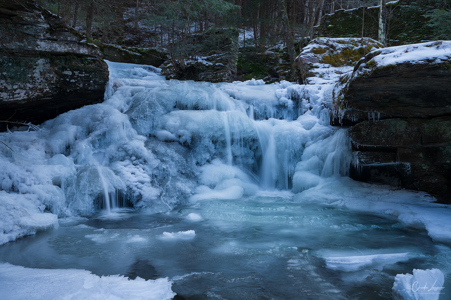 View of frozen Tompkins Falls upstate New York during winter.