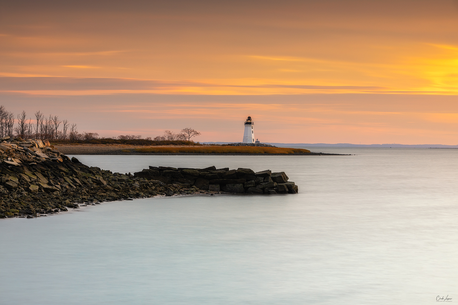 View of Fayerweather Lighthouse in Bridgeport Connecticut at sunset.