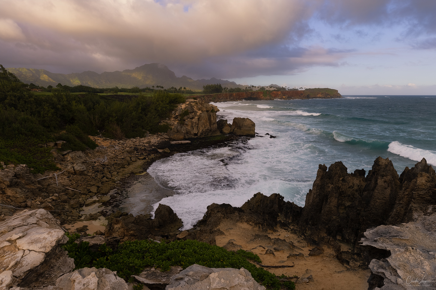 Overlook on the breaking waves and cliffs from Mahaulepu Heritage Trail near Shipwreck Beach on Kauai island in Hawaii.