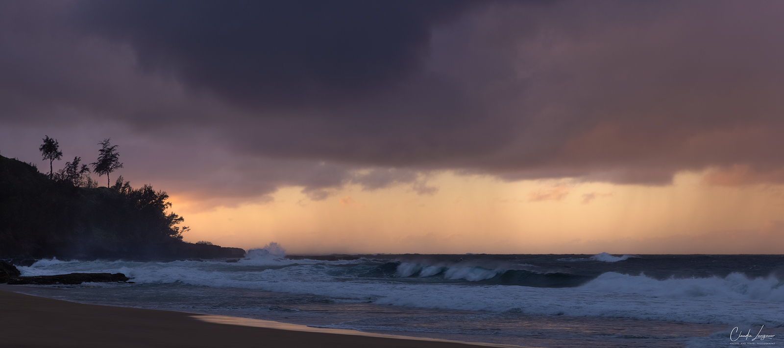 Dramatic clouds and waves at Secret Beach on Kauai's north shore in Hawaii.