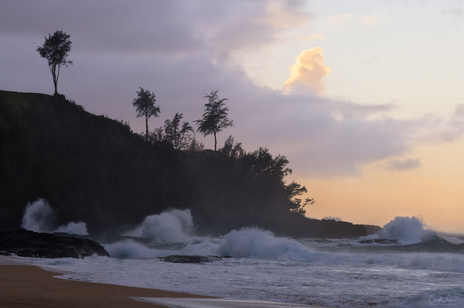 Dramatic clouds and waves at Secret Beach on Kauai's north shore in Hawaii.